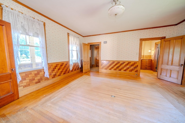 443 S Union Rd, Union, ME 04862 - unfurnished room featuring light wood finished floors, wallpapered walls, wainscoting, and ornamental molding