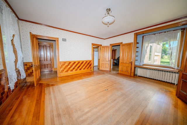 interior space featuring radiator, hardwood / wood-style floors, and crown molding