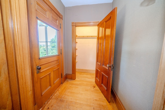 corridor with light wood-type flooring