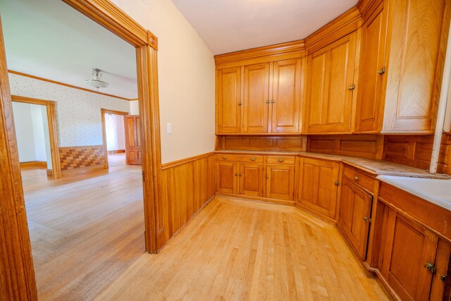 443 S Union Rd, Union, ME 04862 - interior space with a wainscoted wall, light wood-type flooring, brown cabinets, and wallpapered walls