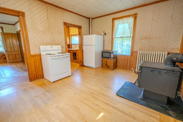 kitchen featuring radiator, light hardwood / wood-style flooring, white appliances, and crown molding