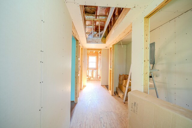 corridor featuring electric panel and hardwood / wood-style floors