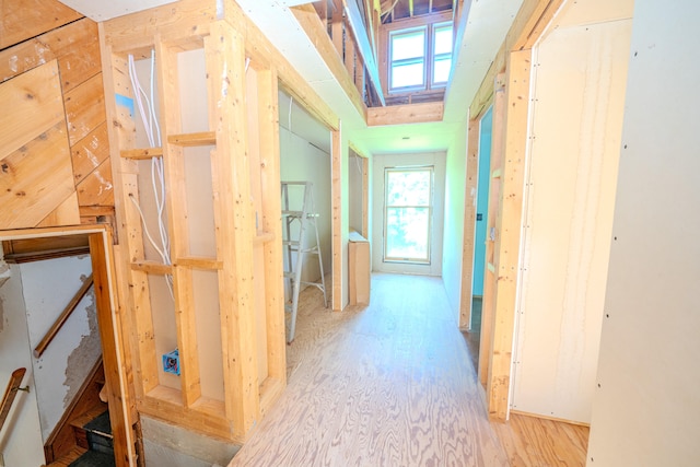 corridor with light hardwood / wood-style floors