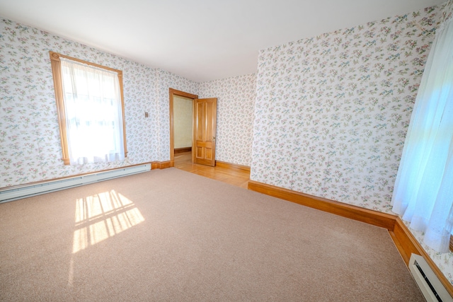 carpeted spare room featuring a baseboard radiator