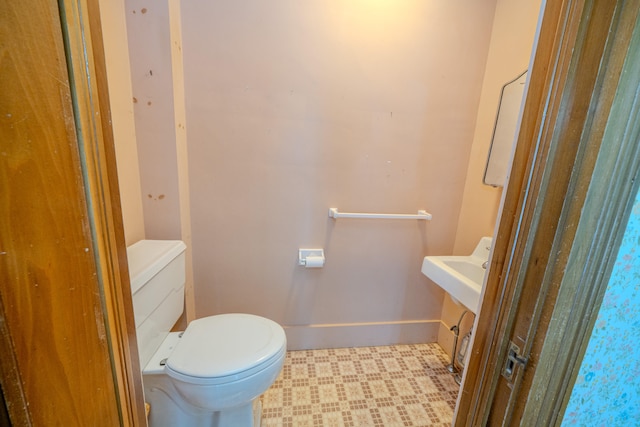 bathroom featuring vanity, toilet, and tile patterned flooring