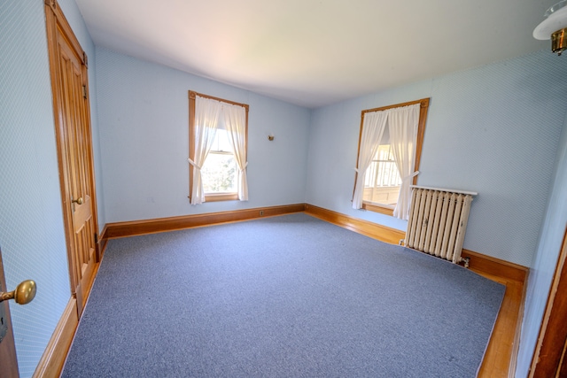 carpeted spare room with radiator