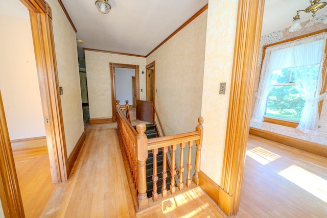 443 S Union Rd, Union, ME 04862 - corridor featuring light wood-style flooring, wallpapered walls, baseboards, crown molding, and an upstairs landing