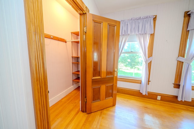 bedroom with lofted ceiling and light hardwood / wood-style floors