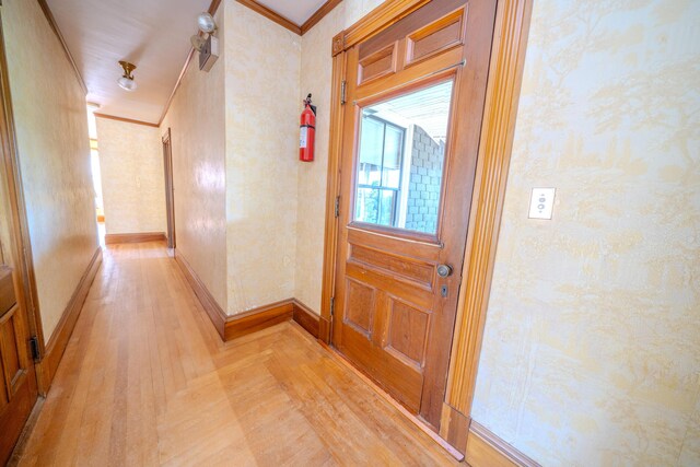 corridor featuring light hardwood / wood-style flooring and ornamental molding