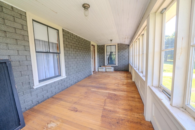 443 S Union Rd, Union, ME 04862 - unfurnished sunroom featuring brick wall, wood-type flooring, and wood ceiling