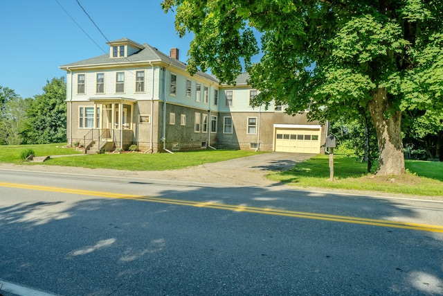 443 S Union Rd, Union, ME 04862 - view of front facade featuring concrete driveway, a chimney, and a front lawn
