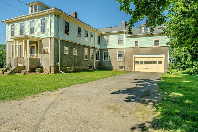 443 S Union Rd, Union, ME 04862 - view of front of house with an attached garage, driveway, stucco siding, a front yard, and a chimney