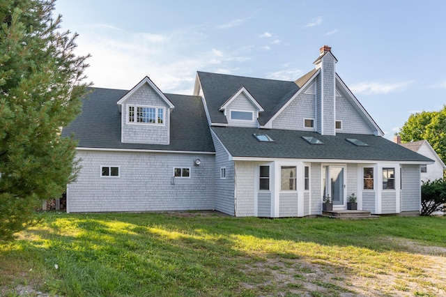 rear view of house featuring a yard