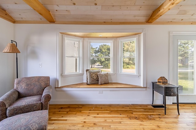 living area with a healthy amount of sunlight, wood ceiling, and hardwood / wood-style flooring