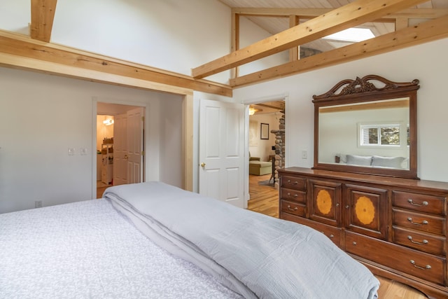 bedroom with beamed ceiling and high vaulted ceiling