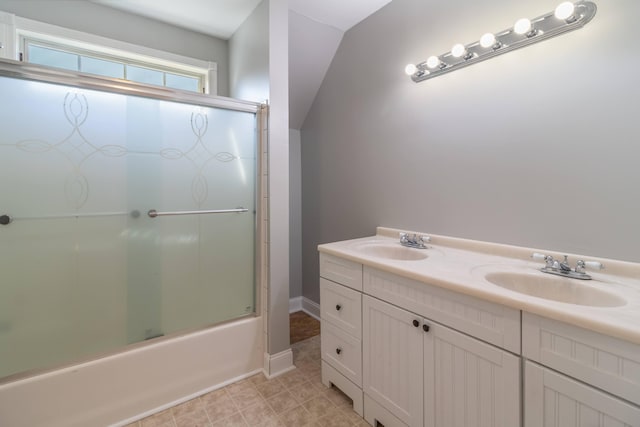 full bathroom with a sink, baseboards, combined bath / shower with glass door, and double vanity