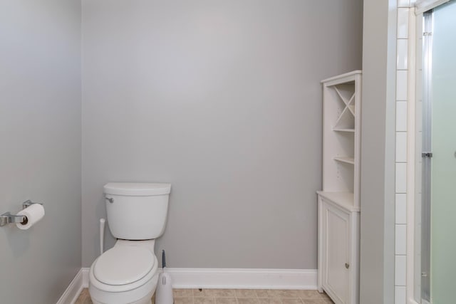 bathroom with toilet and baseboards