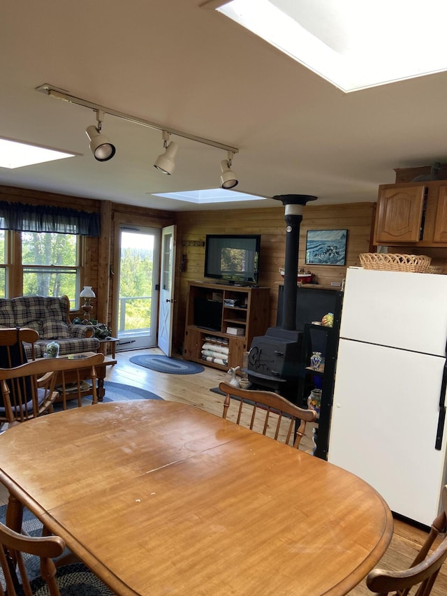 91 Mcsorley Rd, Great Cranberry, Cranberry Isles, ME 04625 - dining area featuring a wood stove, wood walls, and wood finished floors