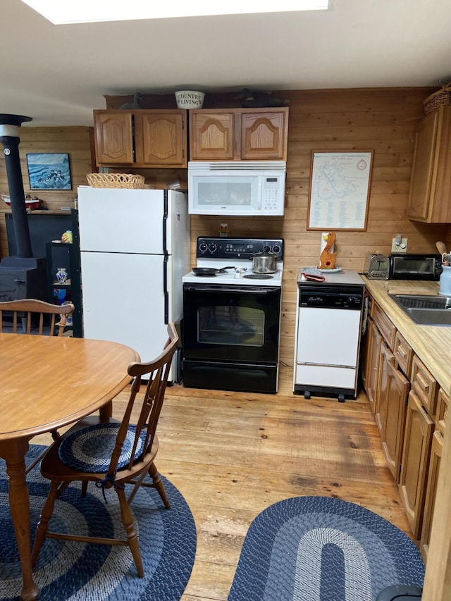 91 Mcsorley Rd, Great Cranberry, Cranberry Isles, ME 04625 - kitchen featuring light wood-type flooring, white appliances, light countertops, and wooden walls