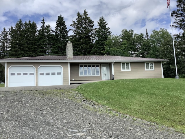 ranch-style home featuring gravel driveway, a front yard, a chimney, metal roof, and an attached garage