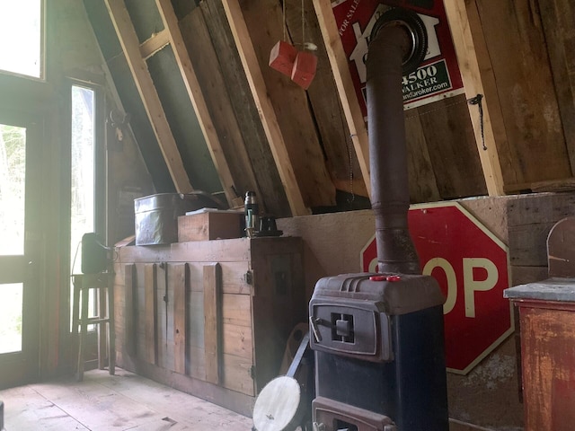 miscellaneous room with a wood stove and a wealth of natural light