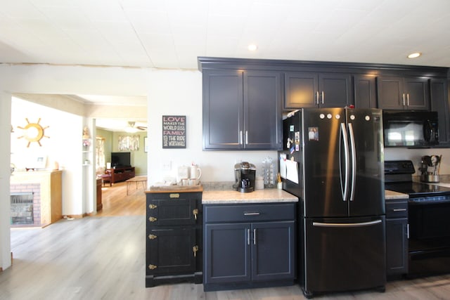 kitchen with black appliances and light wood-type flooring