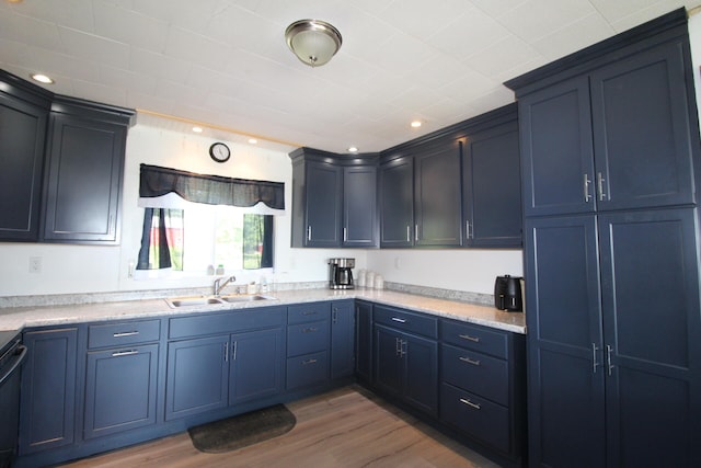 kitchen featuring blue cabinetry, hardwood / wood-style floors, and sink