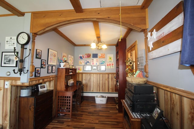 interior space featuring wooden walls, a chandelier, baseboard heating, and dark hardwood / wood-style flooring