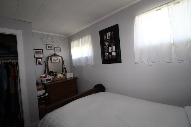 bedroom featuring a closet and crown molding