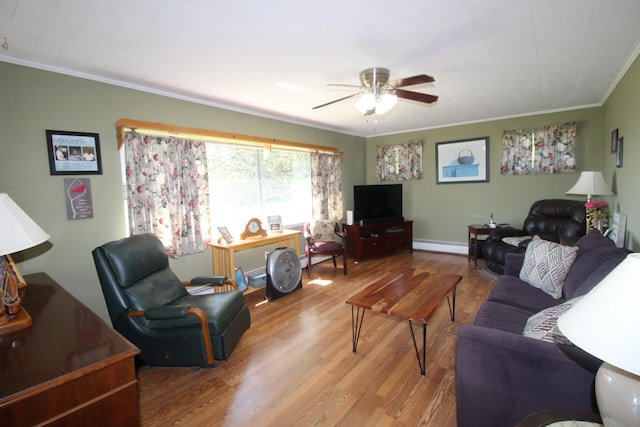 living room with ornamental molding, hardwood / wood-style floors, a baseboard heating unit, and ceiling fan