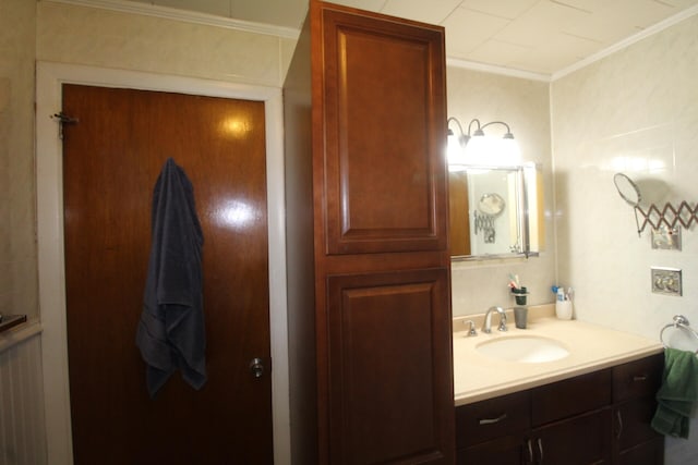 bathroom with vanity and ornamental molding