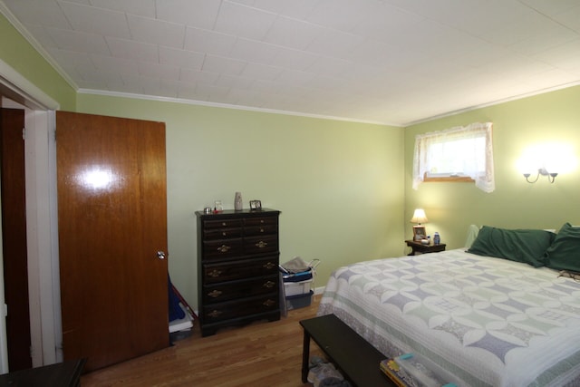 bedroom featuring crown molding and hardwood / wood-style floors