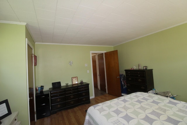 bedroom with crown molding and dark hardwood / wood-style floors