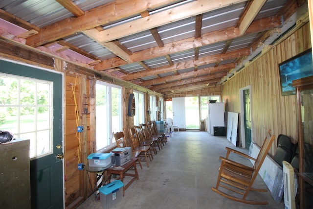 miscellaneous room featuring lofted ceiling, concrete flooring, and heating unit