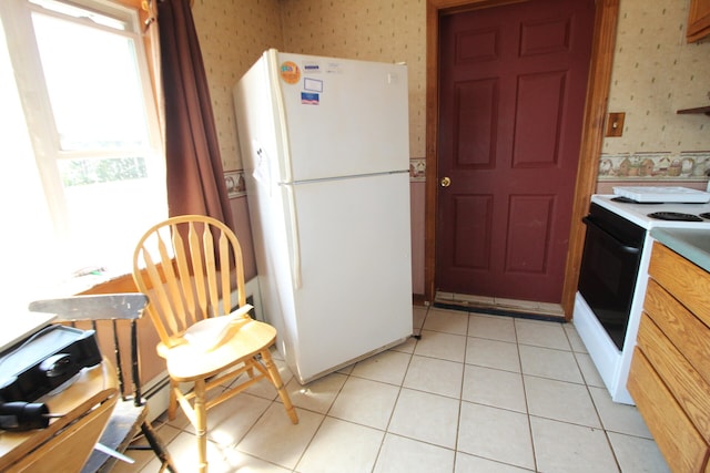 kitchen featuring white appliances and light tile patterned floors