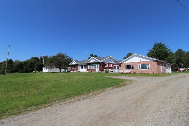 ranch-style home with a front lawn and covered porch