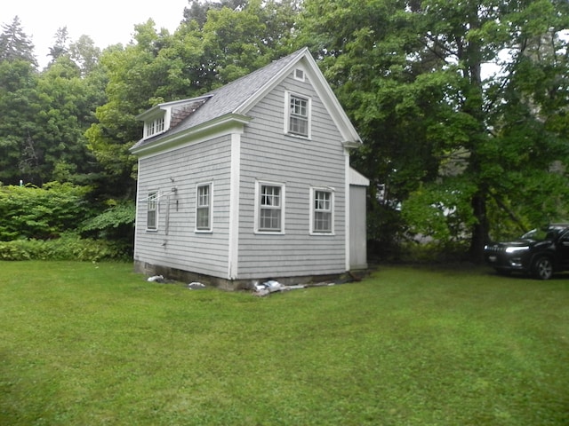 view of property exterior featuring a lawn