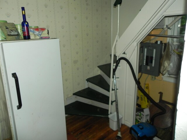 6 Sardine Way, Lubec, ME 04652 - stairs featuring wallpapered walls, electric panel, and wood finished floors