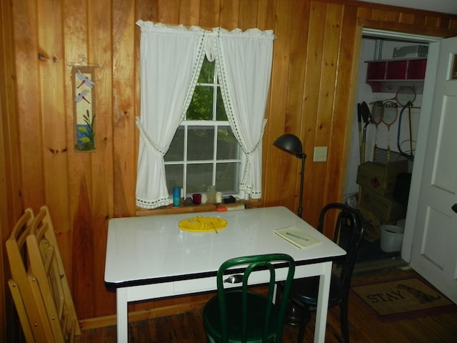 dining area featuring wood walls