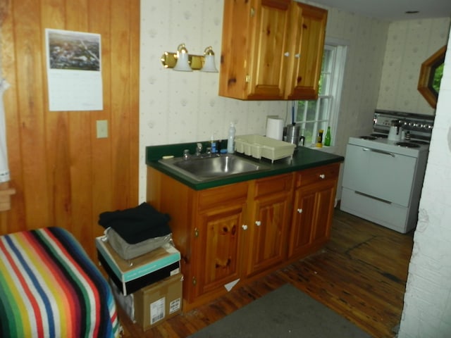 6 Sardine Way, Lubec, ME 04652 - kitchen featuring wallpapered walls, dark countertops, brown cabinetry, washer / dryer, and dark wood-style floors