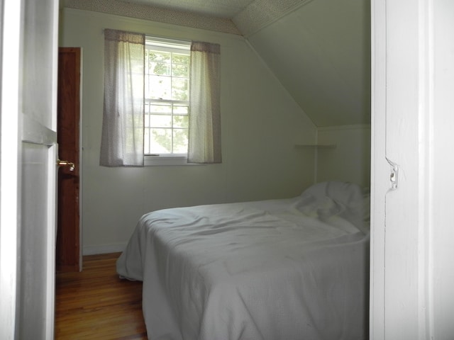 6 Sardine Way, Lubec, ME 04652 - bedroom with vaulted ceiling, baseboards, and wood finished floors