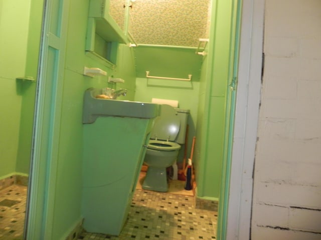 6 Sardine Way, Lubec, ME 04652 - interior space with tile patterned floors, toilet, concrete block wall, and vanity