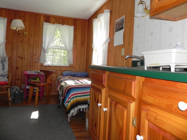 bedroom with wooden walls and dark wood-type flooring