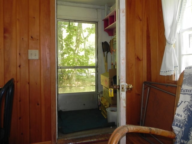 entryway with wooden walls