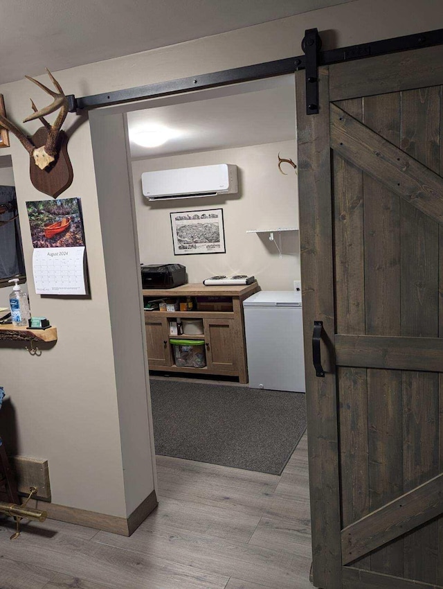 interior space with washer / dryer and a wall mounted AC