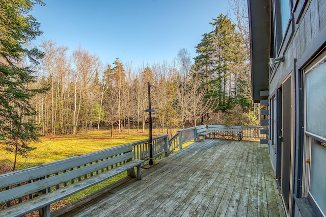 wooden terrace featuring a yard