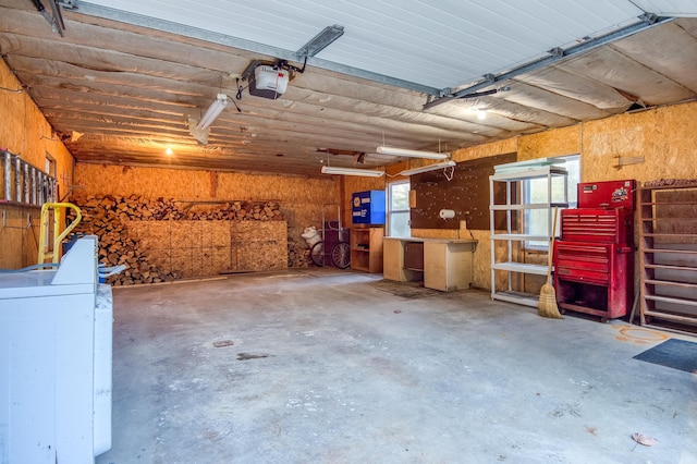 garage with washer / clothes dryer and a garage door opener