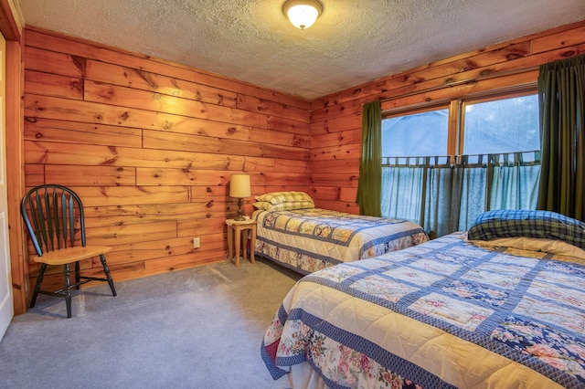 carpeted bedroom featuring wood walls and a textured ceiling