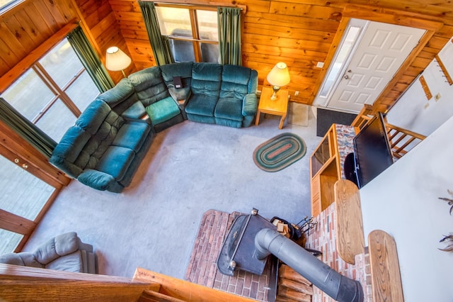 living room featuring wooden walls and high vaulted ceiling