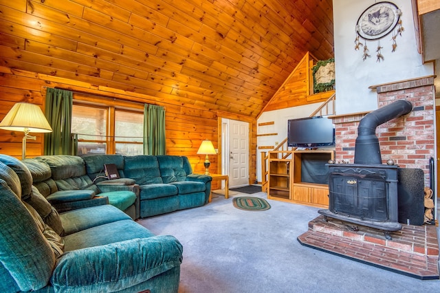 carpeted living room featuring high vaulted ceiling, a wood stove, wooden walls, and wooden ceiling